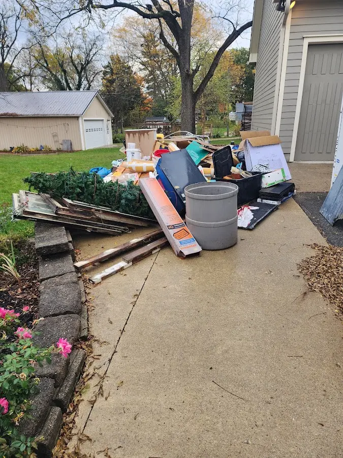 Dumpster being loaded with debris for Roofing Dumpster Rental in Fort Smith